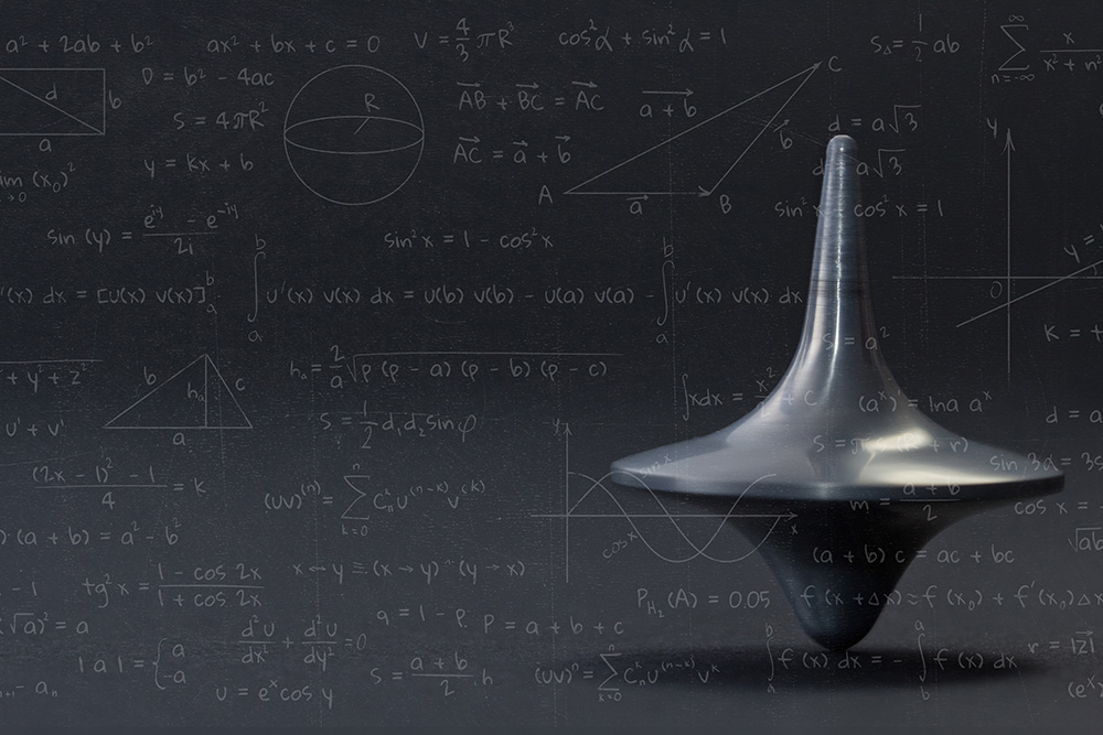 Mathematics and Quantum Science. Spinning top with maths equations on top.