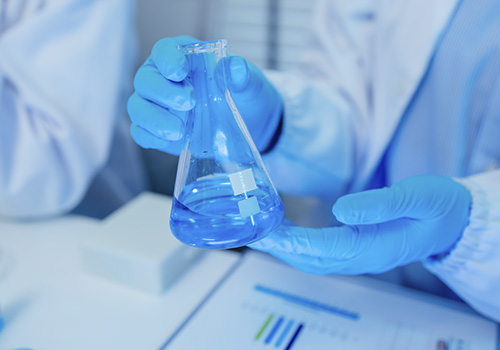 Lab safety – lab technician wearing a lab coat and gloves